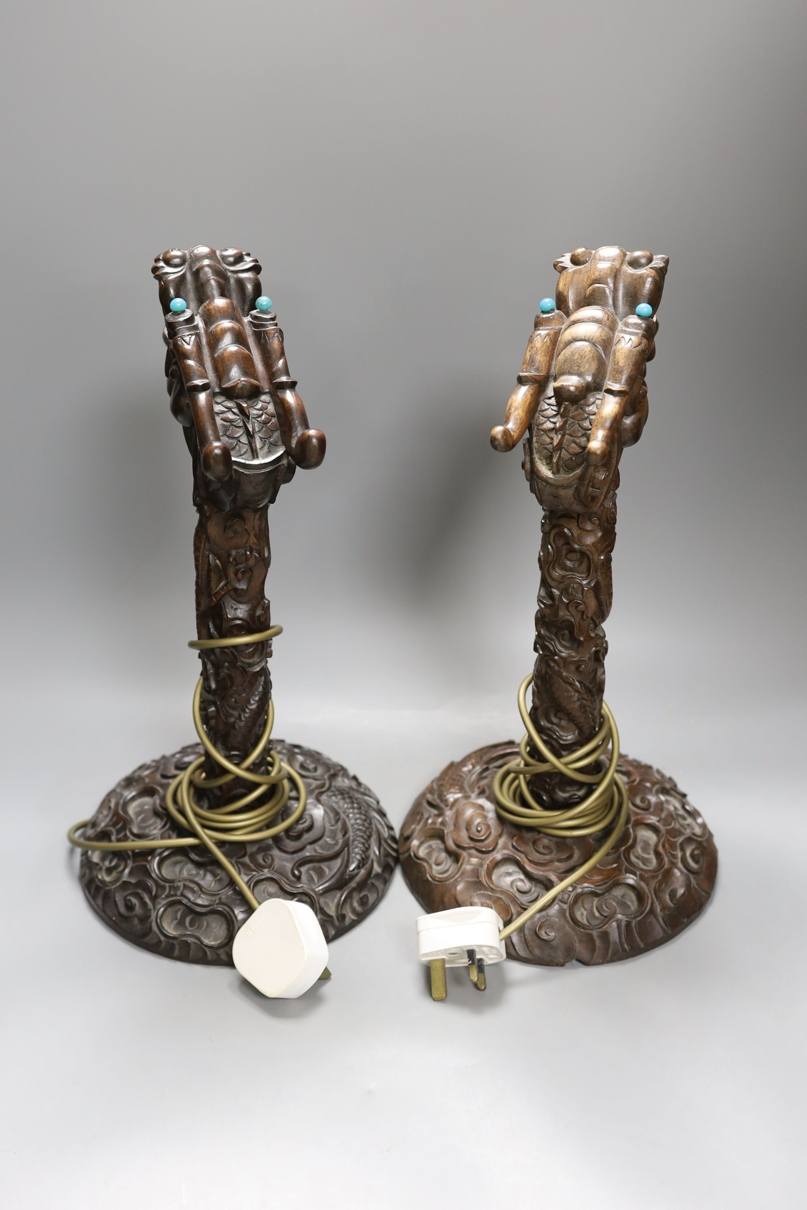 A pair of Chinese carved hongmu dragon lamps - 40cm tall